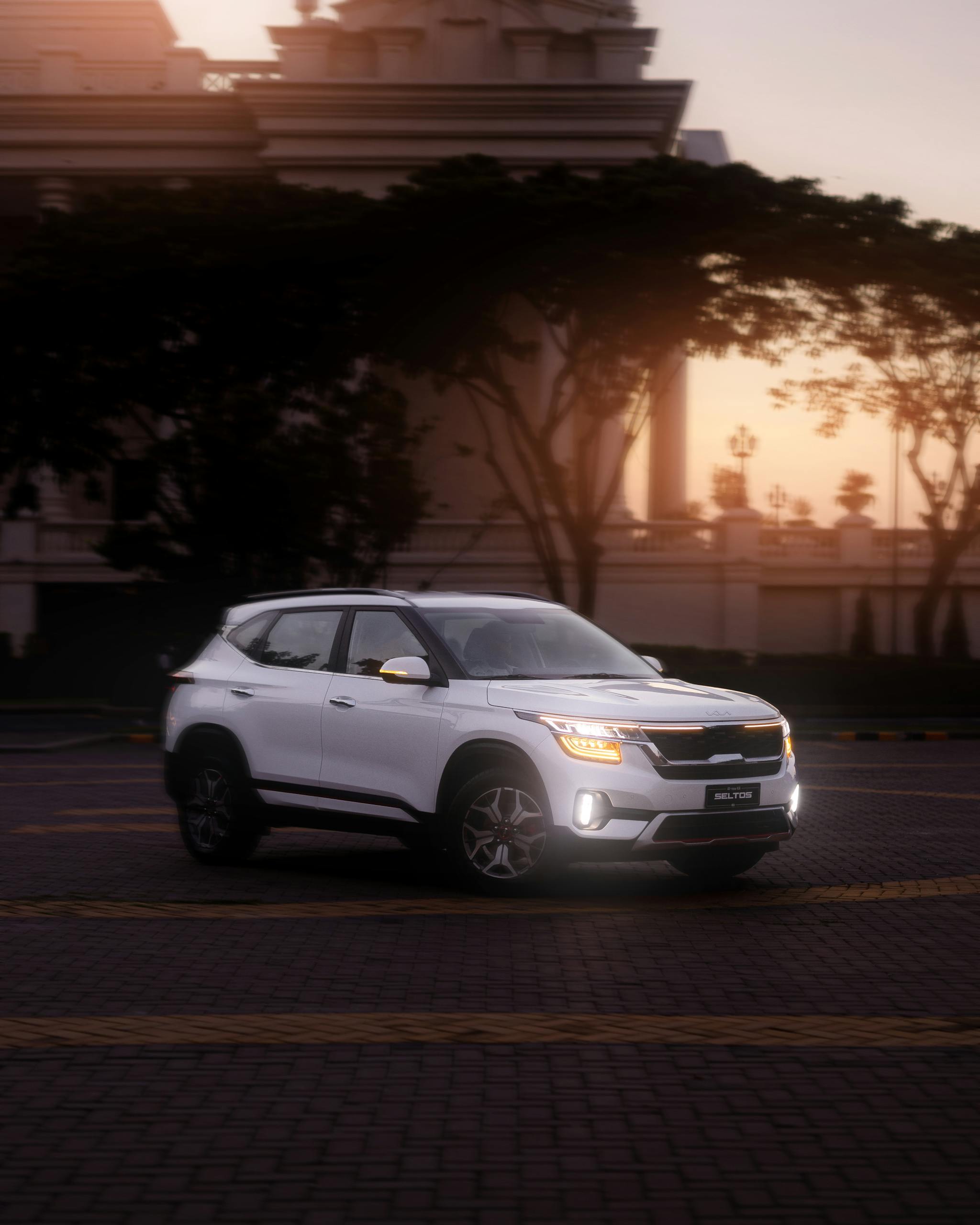 White SUV parked against a backdrop of sunset in Phnom Penh, Cambodia.